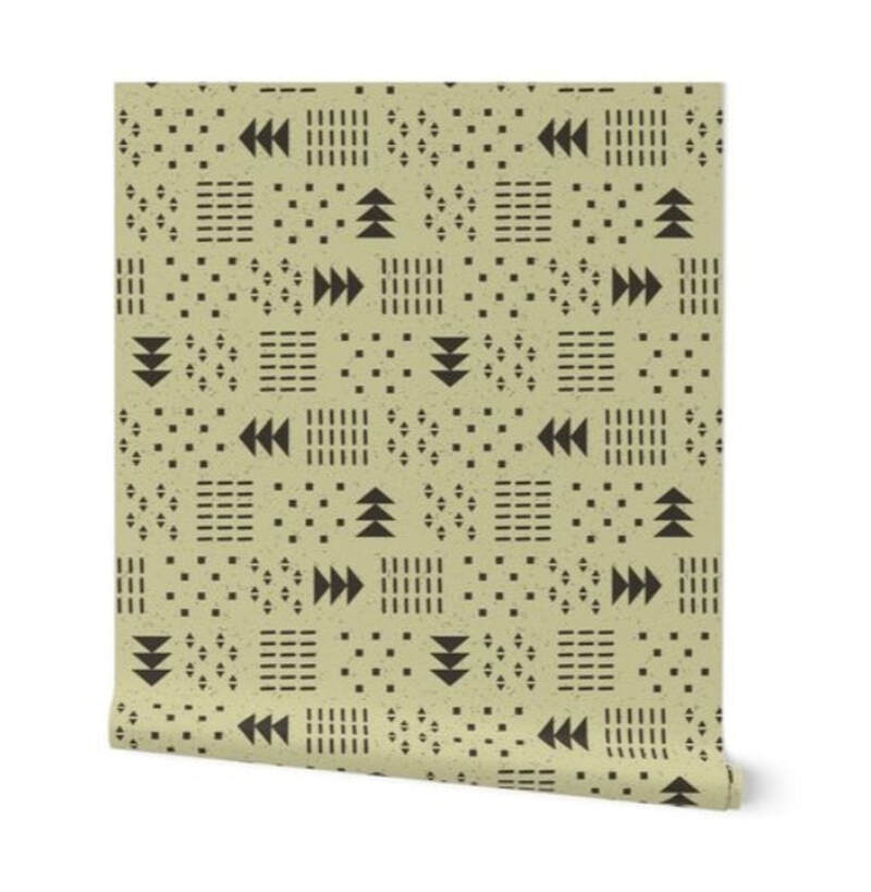 A partially unrolled roll of wallpaper showing "Sandcloth" pattern by Merry Makewell Designs